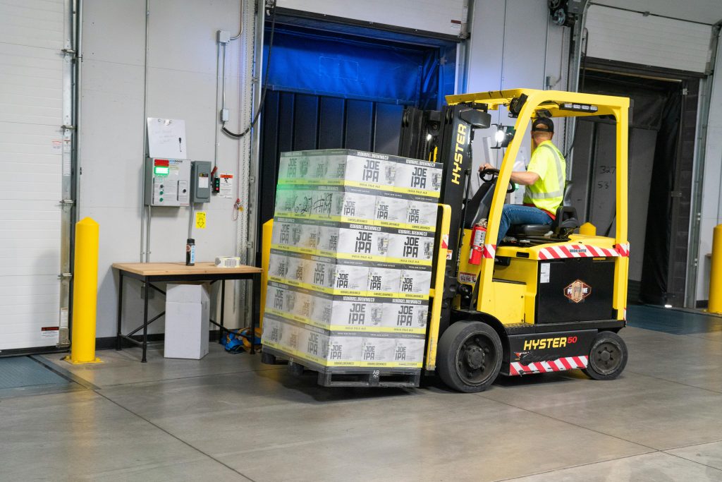 pexels photo 1267329 1267329 A warehouse employee operating a forklift to move stocked goods indoors. Perfect for industry and logistics visuals.